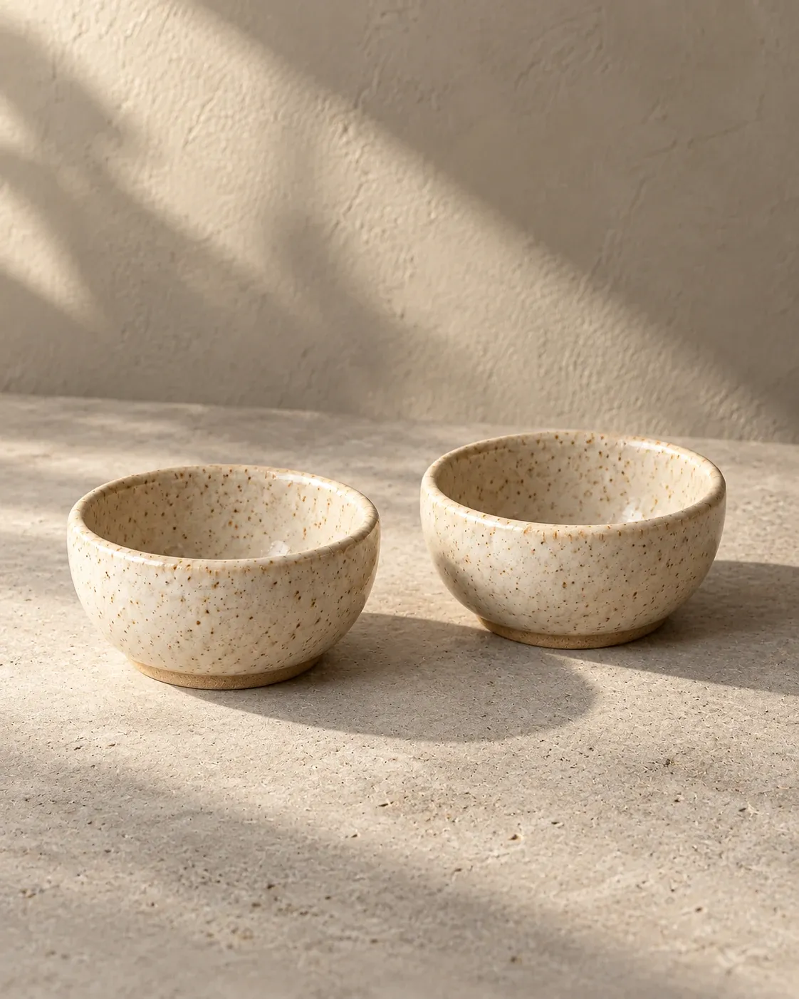 Pinch Pair in Oat, a warm pale glaze, exactly two small bowls